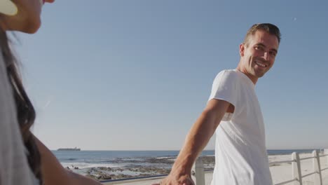 young adult couple having fun at the seaside