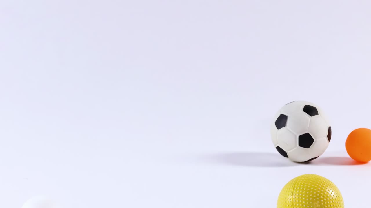 A dynamic display of colorful balls bouncing and interacting on a white background.