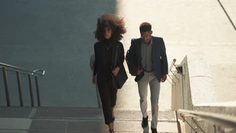 Business,-woman-and-man-walk-on-stairs-outdoor