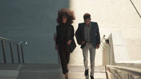 business, woman and man walk on stairs outdoor