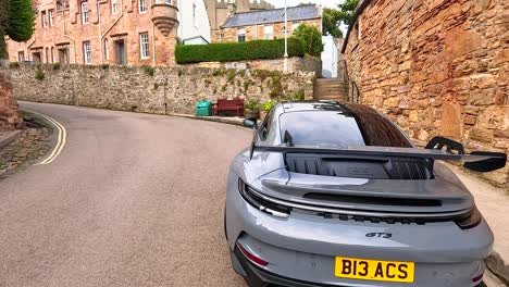 a car navigates a narrow street in crail