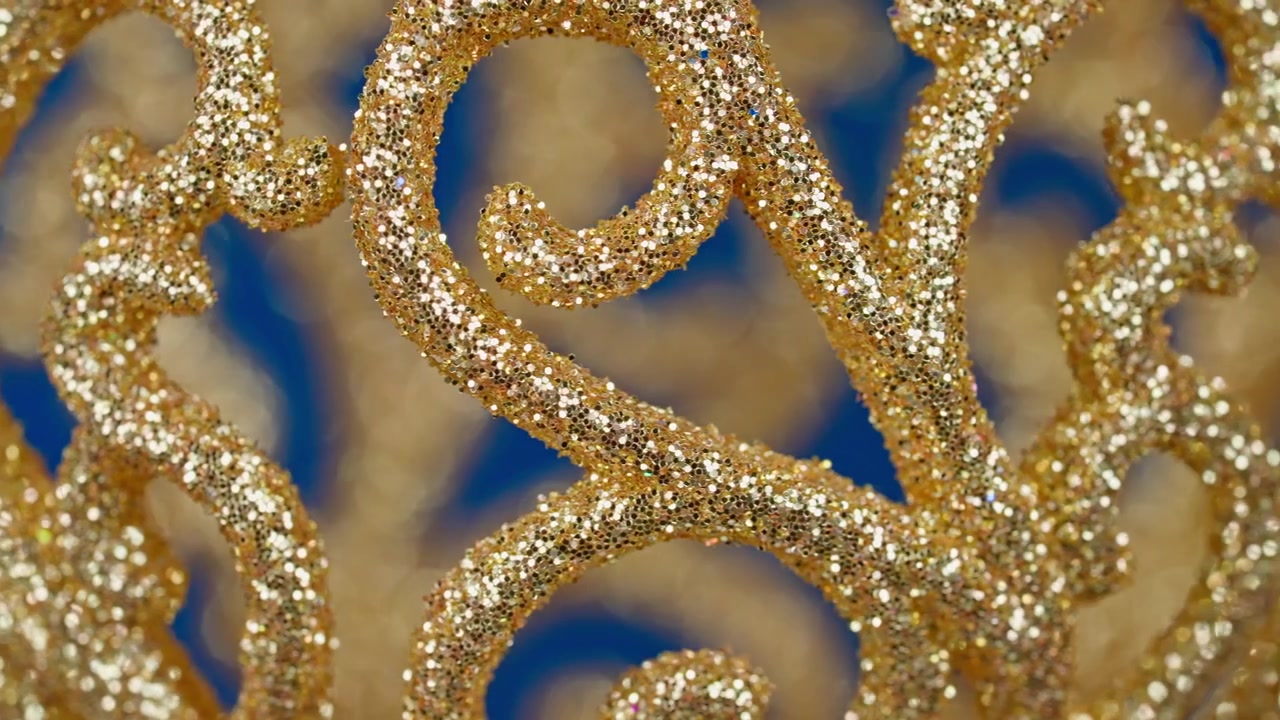 Motivo ornamentale con glitter dorati scintillanti su sfondo blu
