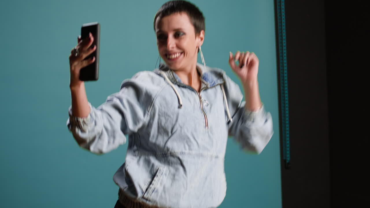 Woman taking a selfie in studio