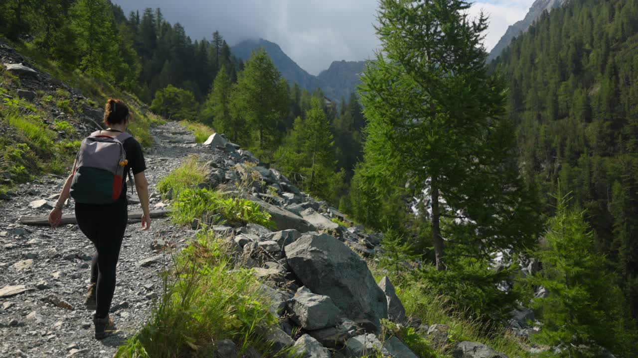 mujer haciendo trekking en val ventina de valtellina en el norte de italia