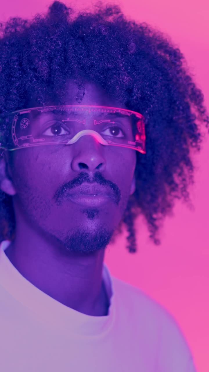 Man Wearing Futuristic AR Glasses in Neon Lighting
