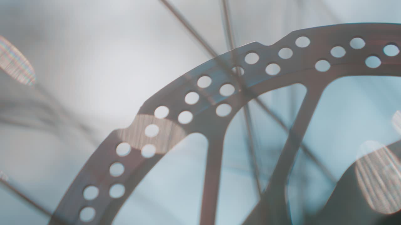 Close-up of a bicycle brake rotor with light reflections, creating a dreamy atmosphere