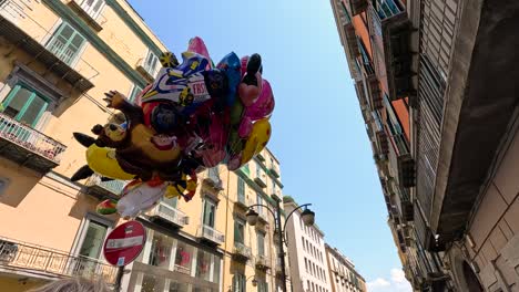 balloons floating between buildings in naples, italy