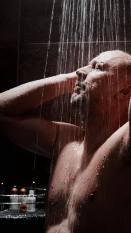 man enjoys refreshing shower while relaxing in a modern bathroom setting