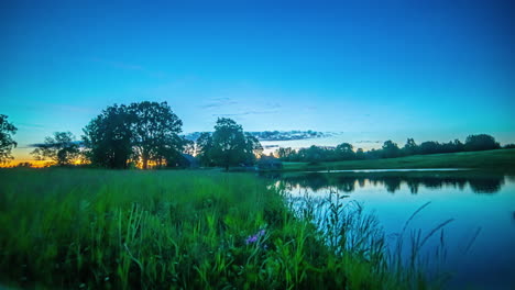 Night-to-sunrise-to-all-day-time-lapse-of-a-cabin-by-a-lake