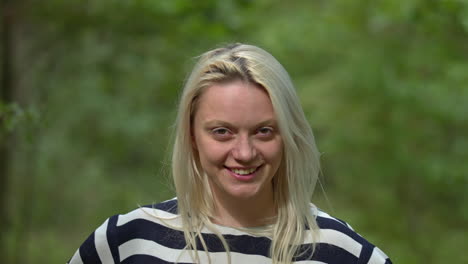 Beautiful-young-girl-smiling-and-posing-outdoor-in-slow-motion,close-up