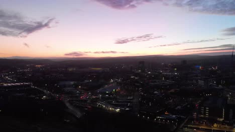 sheffield city centre drone shot over the sky line sheffield hallam bramall lane tall sky scraper aerial shot during sunset night shot sun down blue orange purple sky uk city