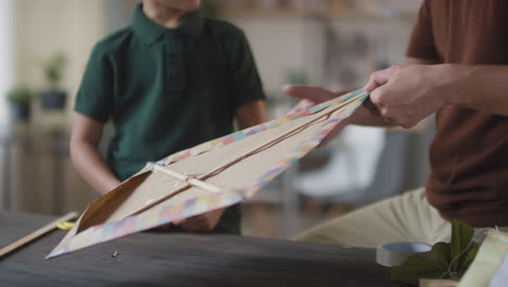 father and son making a kite together