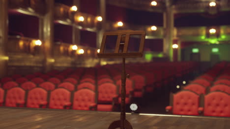 empty stage with a music stand in a theater