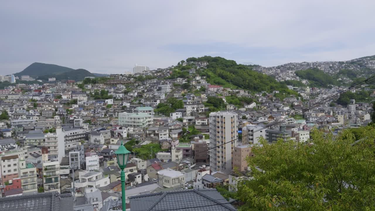 The many hills of Nagasaki city on sunny day. Panning shot
