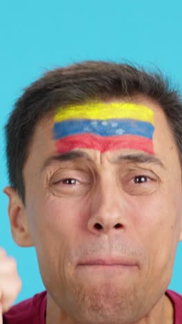 very nervous man supporting venezuelan team during a difficult match