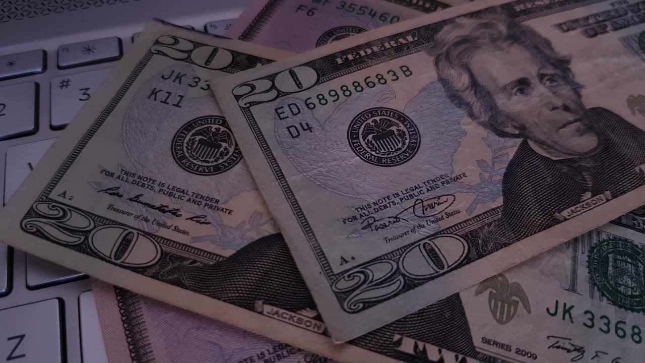 US dollar falling onto gold bitcoin on a keyboard