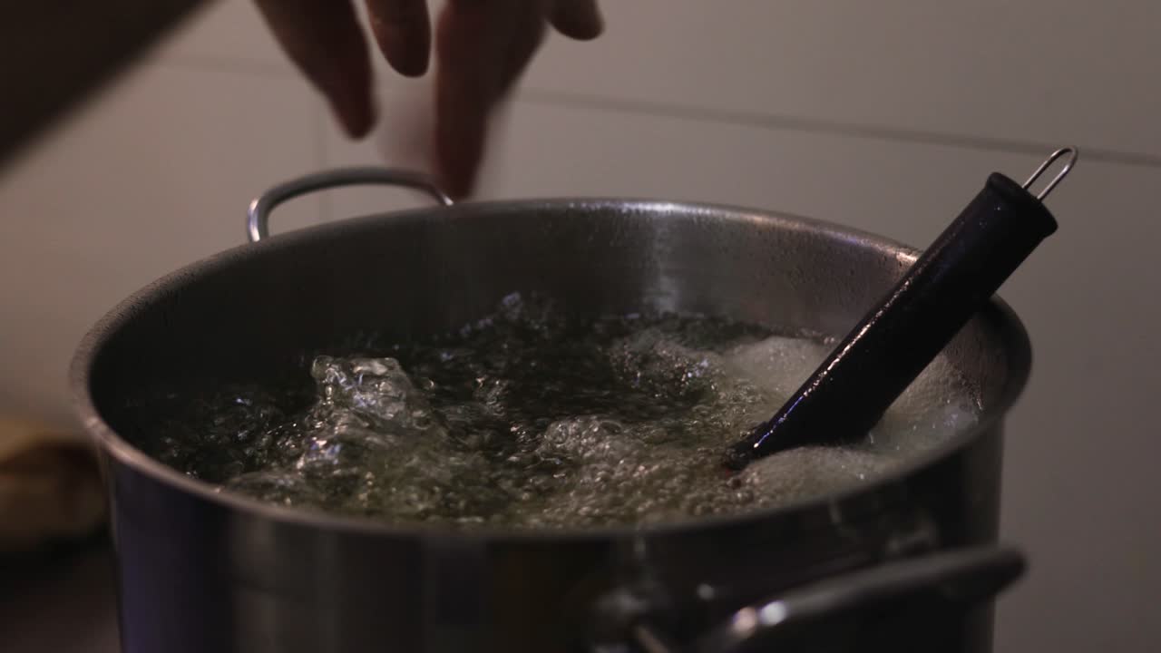 Preparing syrup for dessert in a pot that