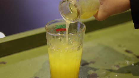 sequence of pouring iced drink into glass