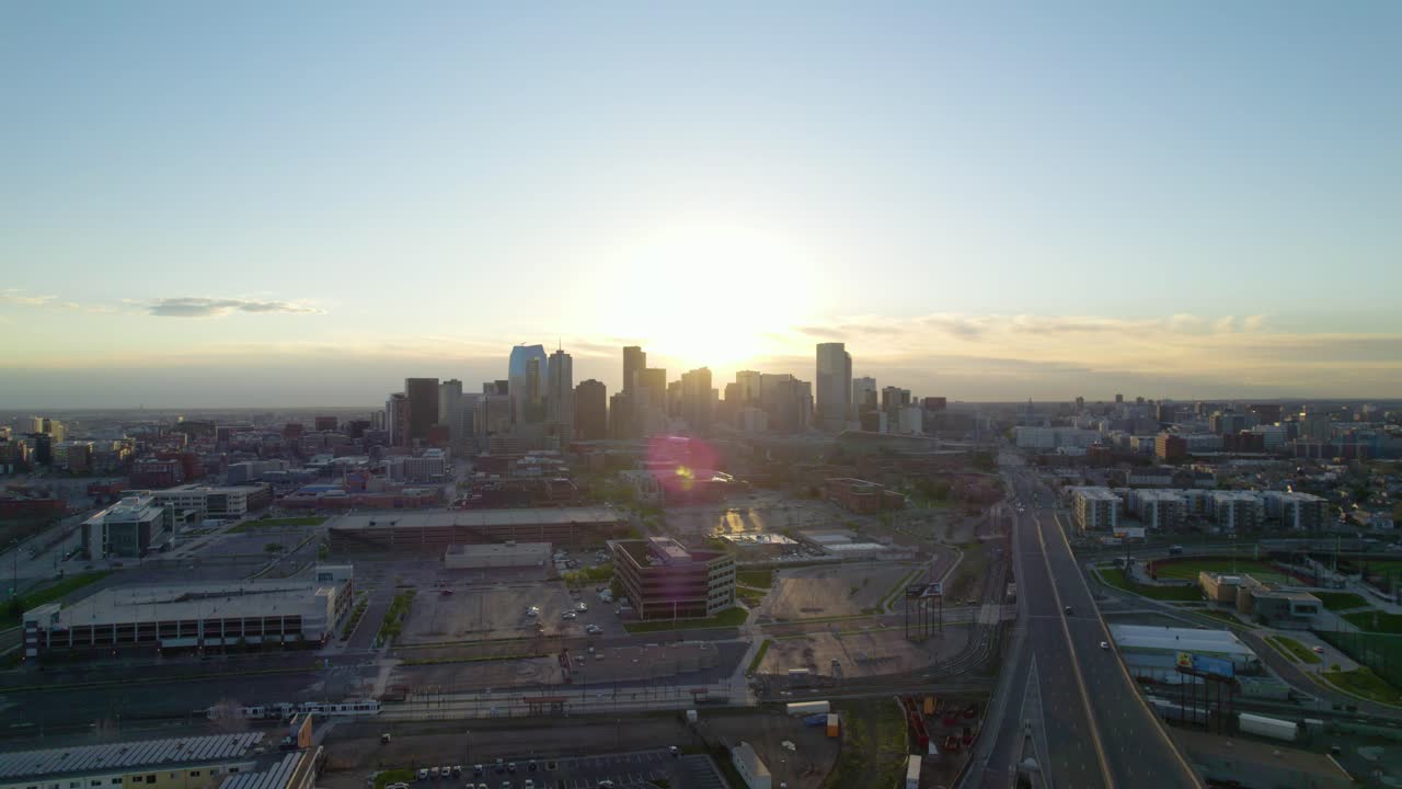 Denver, Colorado USA. Ariel view of distant metropolitan area during sunrise. Skyscrapers and highways paint beautiful cinematic landscape.