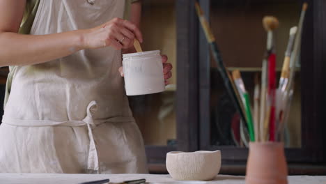 woman working on pottery in her studio