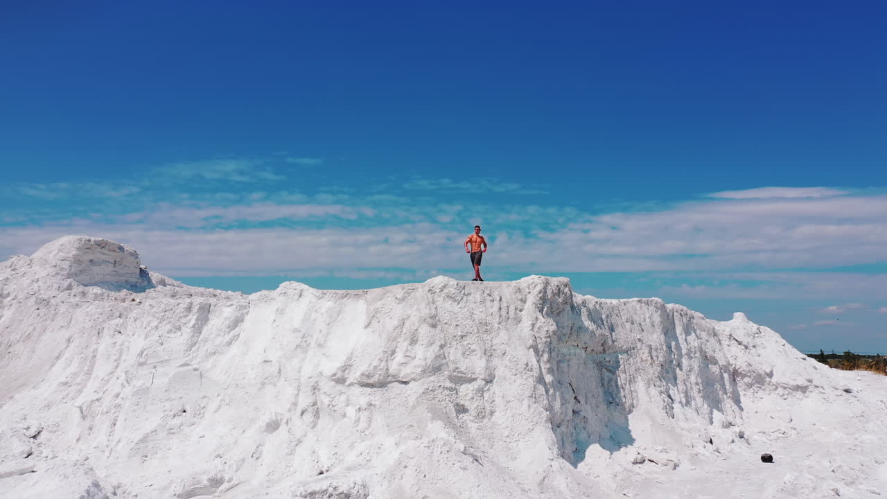 Professional bodybuilder posing outdoors. Concept of beautiful healthy body. Aerial view