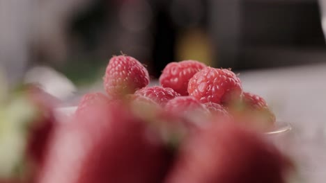 rack focus tasty delicious strawberry to raspberry fruits while cooking healthy dessert close-up shoot