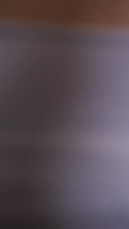 vertical video of focused diverse women meditating together on mats in yoga class, slow motion