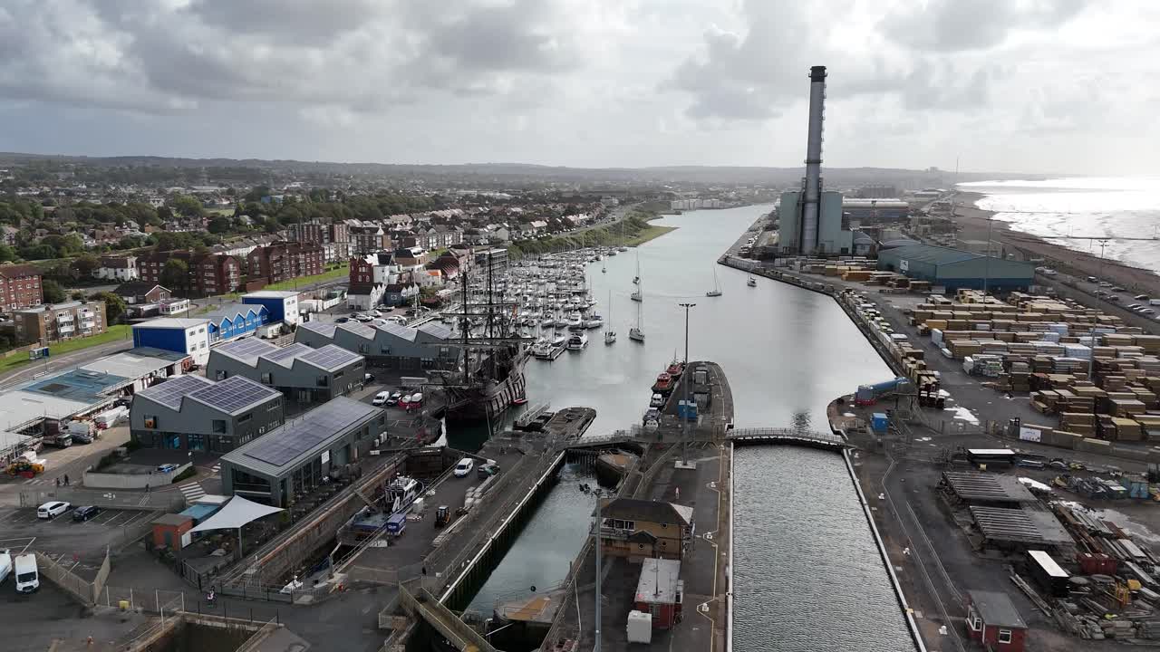 Cinematic aerial footage of Shoreham Harbour and Southwick Canal with the landmark Shoreham Power Station. Stunning mix of industry, shipping, and coastal scenery along the Sussex shoreline