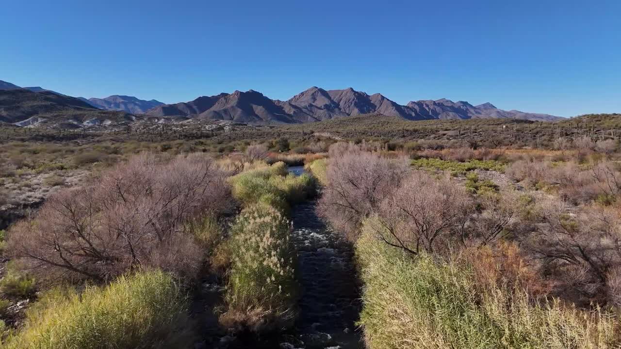 Aerial View of River Flowing In Front of Mountains, Verde River in Arizona