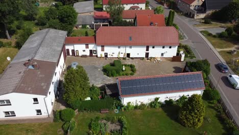 Large-farm,-Pigsty,-Inner-courtyard-Spectacular-aerial-view-360-curve-flight-drone-footage
in-the-village-Hainichen-Europe-Saxony-Anhalt-at-summer-2022