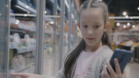 child shopping for frozen foods in a supermarket