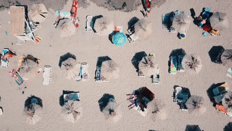 beach umbrellas on a black sea shot from high during a vacation