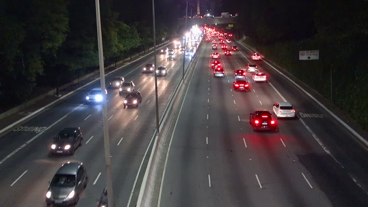 vehicles traffic on 23 de Maio avenue in Sao paulo city, at night. Tilt up view