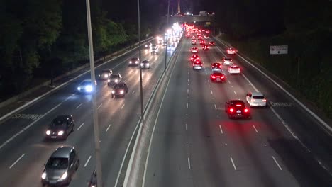 vehicles traffic on 23 de maio avenue in sao paulo city, at night. tilt up view