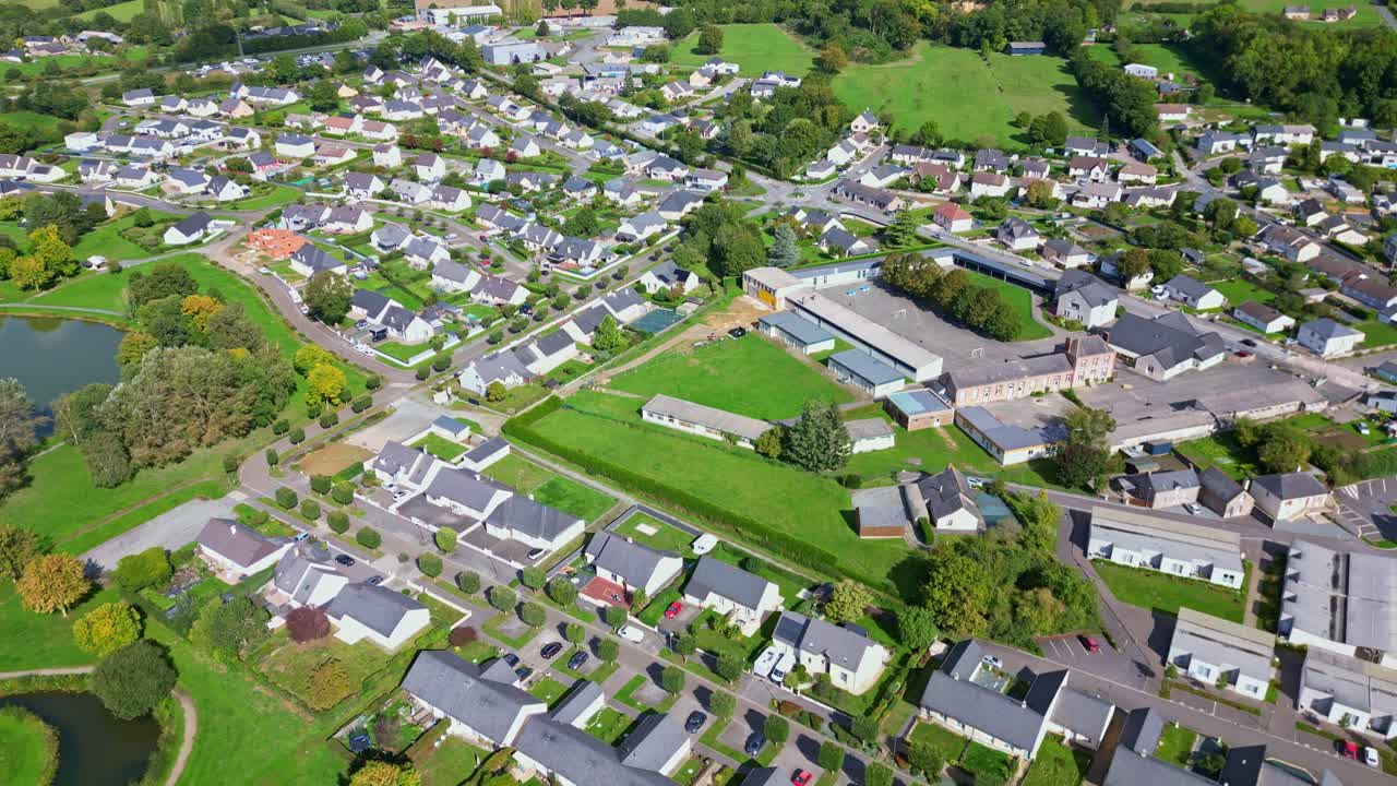 Top-down drone perspective view of center of Saint-Pierre-la-Cour commune with homes, Mayenne, France