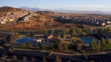 aerial orbital shot around a community pool in a desert master-planned development