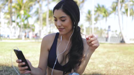 Sportliche-Frau,-Die-Im-Park-Musik-Hört