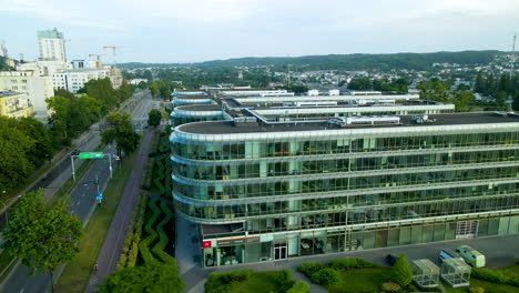 glass exterior view of ppnt building with city traffic in gdynia, poland