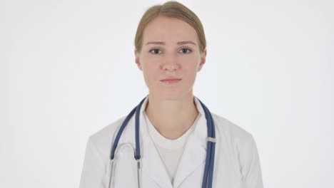 serious female doctor looking at the camera on white background