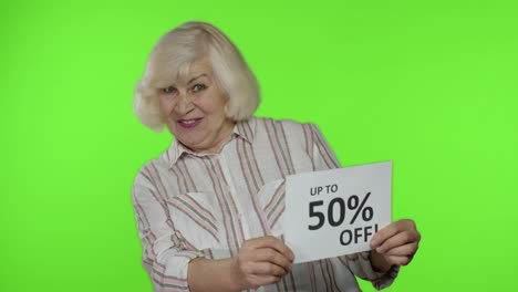 Senior-grandmother-showing-Sale-50-percent-Off-banner-advertisement.-Online-shopping.-Black-Friday