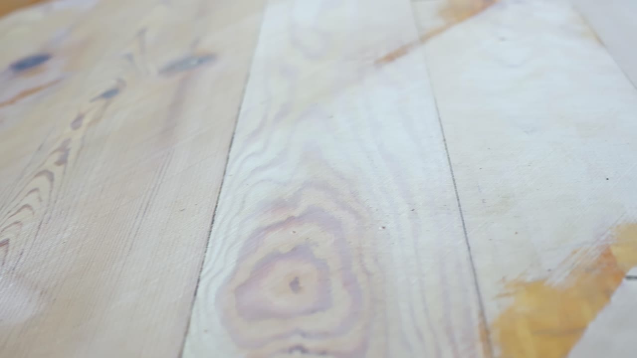 Wooden floor partially sanded showing difference between old finish and exposed grain