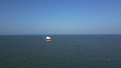 aerial view of tanker ship approaching the coast, sunny day seascape