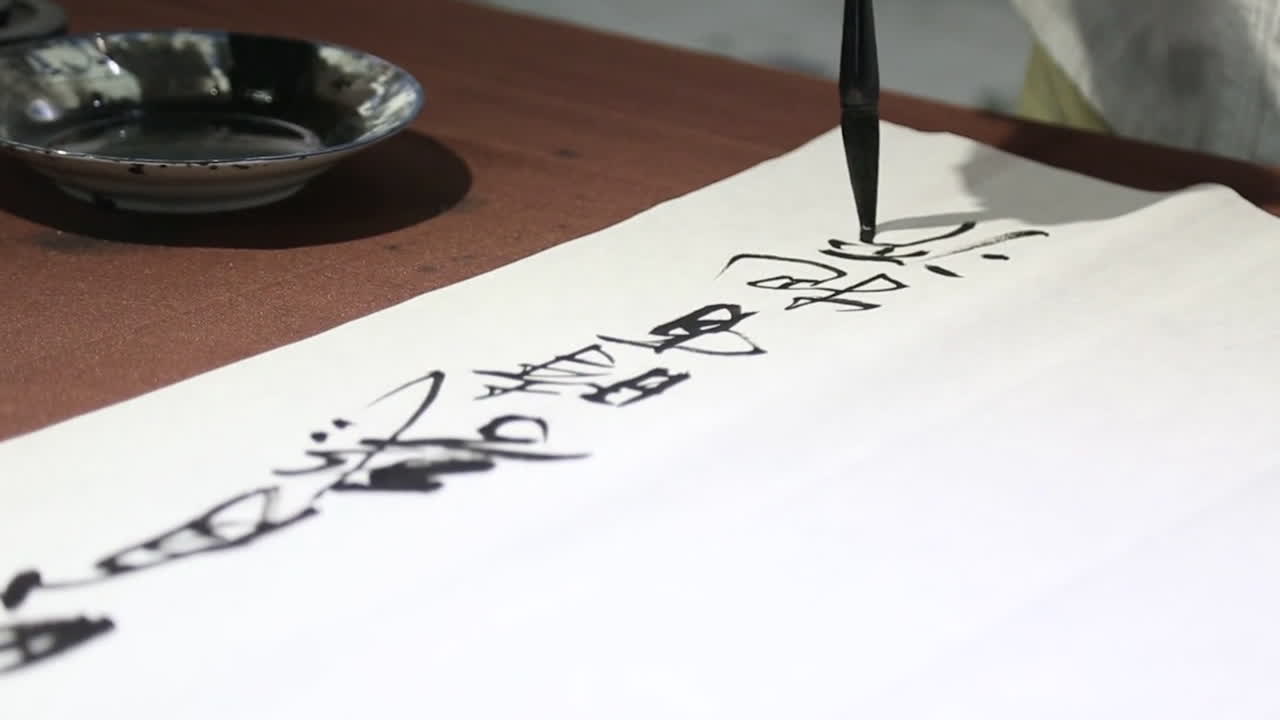 Close-up of a person performing calligraphy