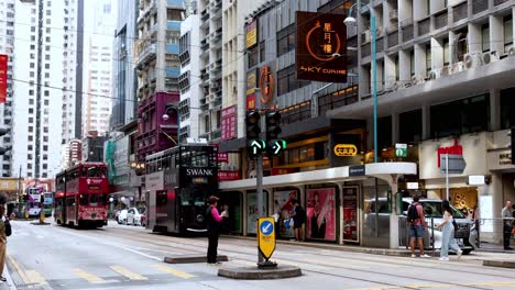 tram moves through busy hong kong street