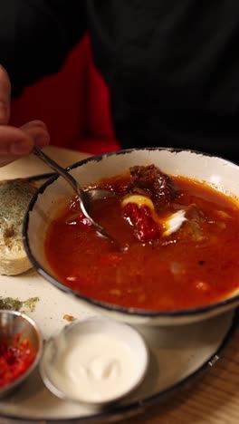 person eating soup