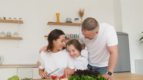 woman preparing a salad for her family woman preparing a salad for her family happy family in the kitchen at home vegetarian food video