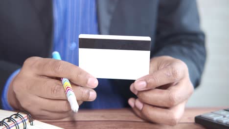 businessman holding a credit card