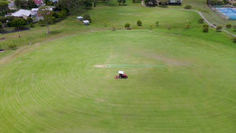 tractor mowing a large sports field