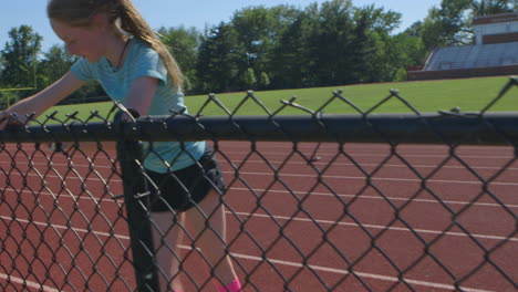 Young-athletic-teenager-warms-up-at-the-high-school-track-before-a-run