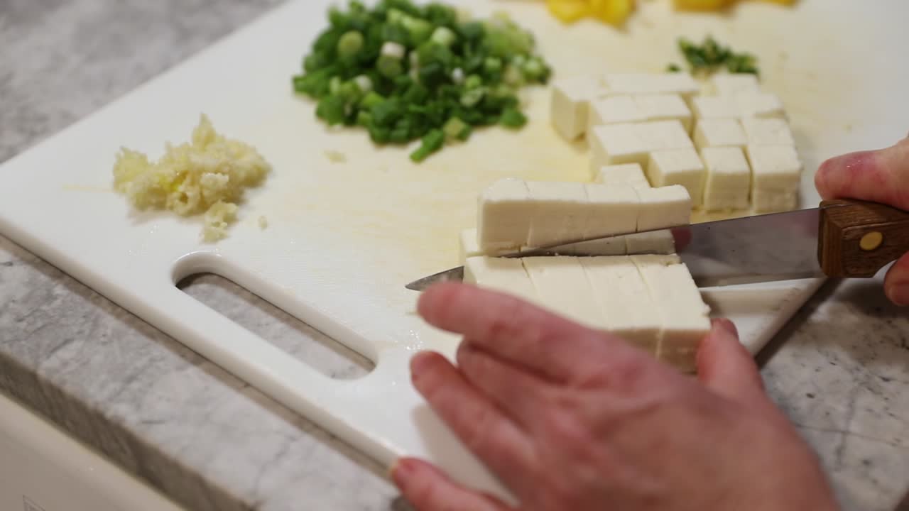 Panning Shot Of Woman Dicing Paneer In Slow Motion